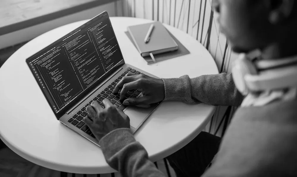 A Technica developer writing code at a web development workstation